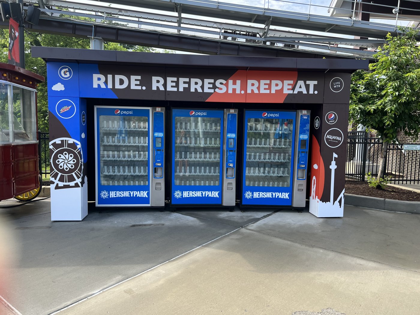 Three-machine outdoor vending enclosure with a roof at Hersheypark