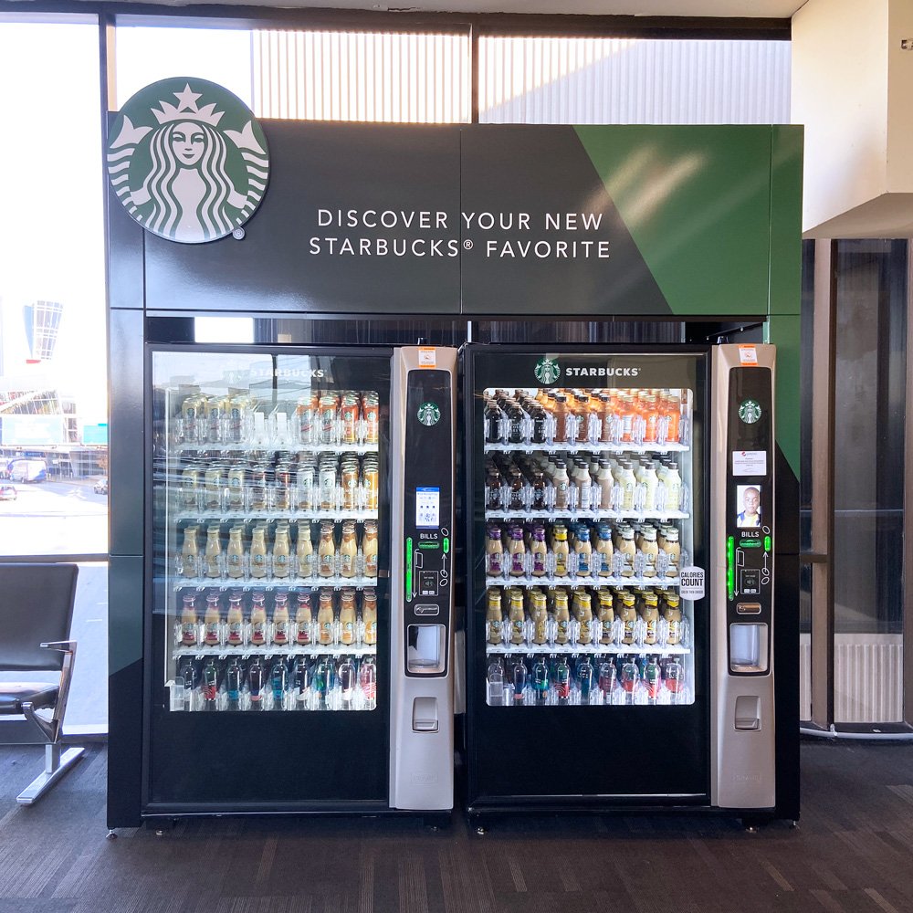 Starbucks indoor vending enclosure with two machines and a Discover your new Starbucks favorite header